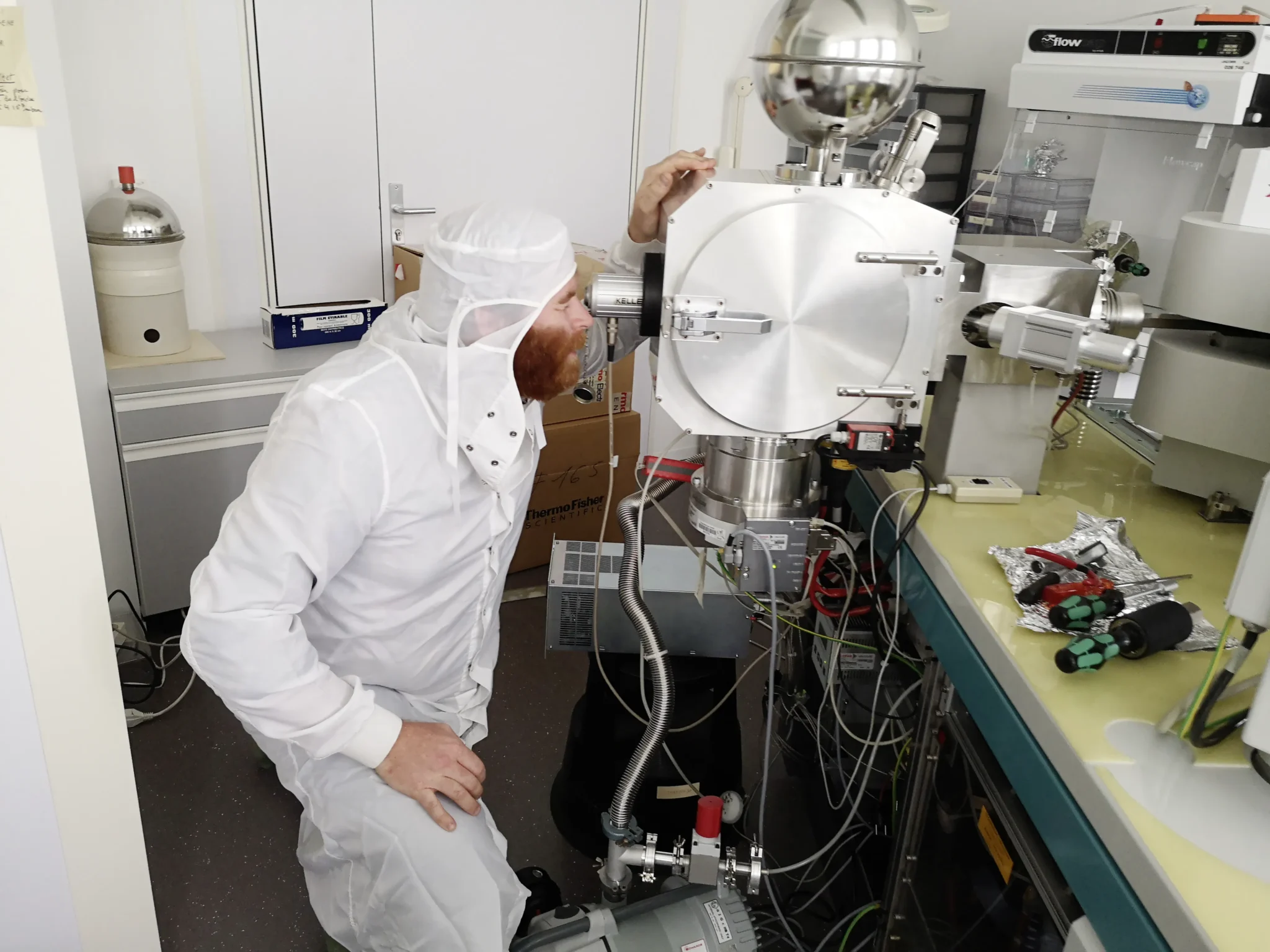 Edward Inglis closely inspecting a TIMS spectrometer