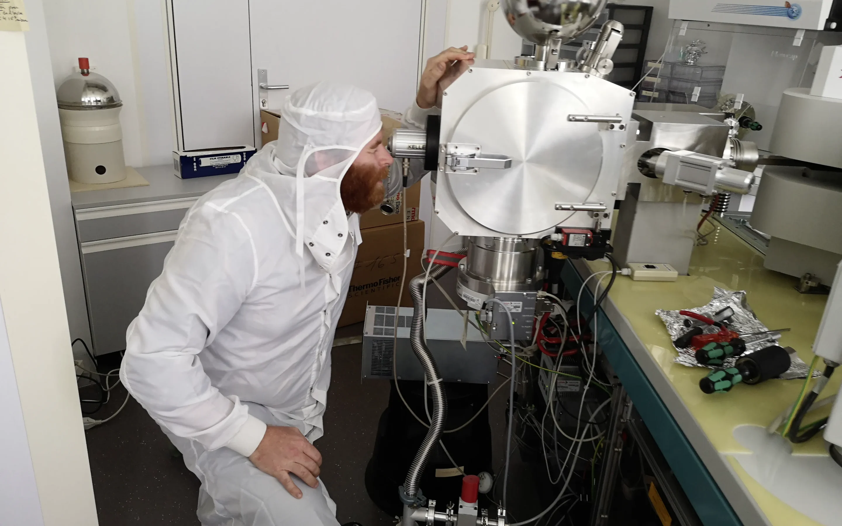 Edward Inglis in front of a TIMS spectrometer in the laboratory